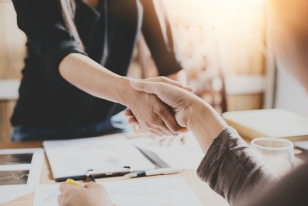 close up of two people shaking hands