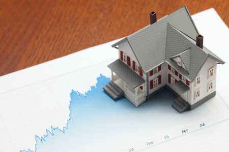 real estate market report concept with house on graph paper